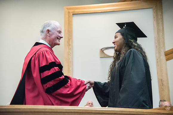 Graduates shake Elder Kim B. Clark's hand before being awarded their Diploma at Convocation of the Sociology and Social Work/Psychology in the Hinckley Chapel. July 2018