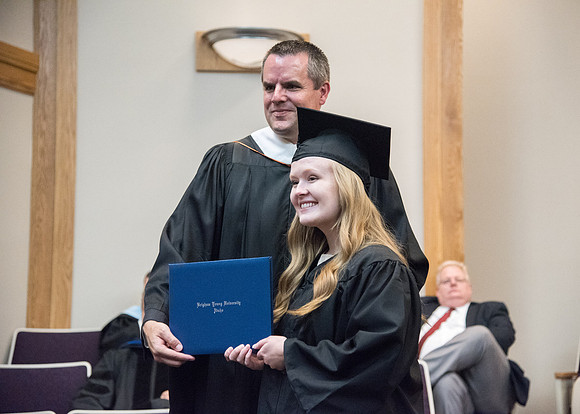 Graduate and Nathan J. Meeker smile for a photo at the Convocation for the Sociology and Social Work/Psychology Departments in the Hinckley Chapel. July 2018