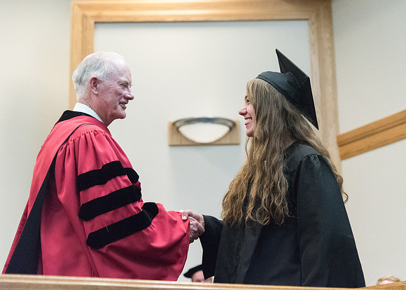 Graduates shake Elder Kim B. Clark's hand before being awarded their Diploma at Convocation of the Sociology and Social Work/Psychology in the Hinckley Chapel. July 2018