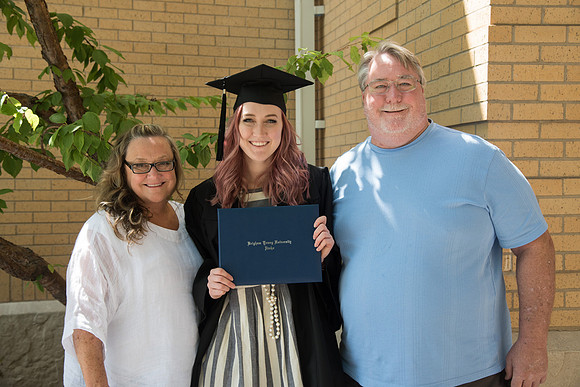 Graduate, Alex Cook and her Parents after Convocation outside the Hinckley Building. July 2018