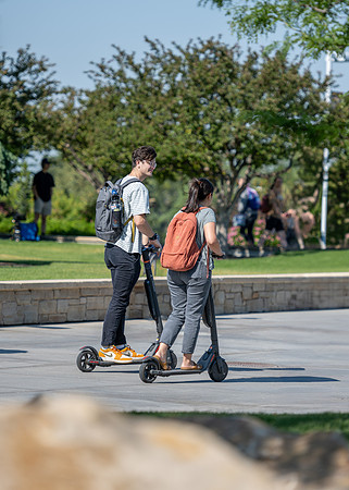 Students ride to class on electric scooters