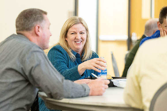 Faculty collaborate with each other over lunch.
