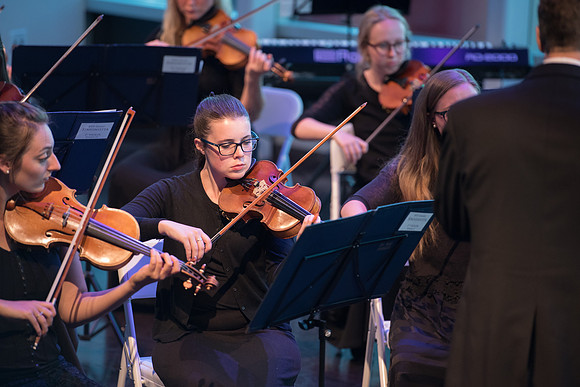 BYU-Idaho Orchestra made up of 24 talented musicians tours the Great Lakes region under direction of Dr. Dallin Hansen. Concert in Cedar Rapids, Iowa in the Whipple Auditorium, Public Library.