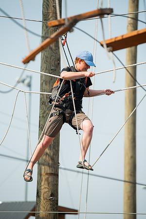 BYUI Students climbing around the ropes course by the upper fields in the summer of 2021.