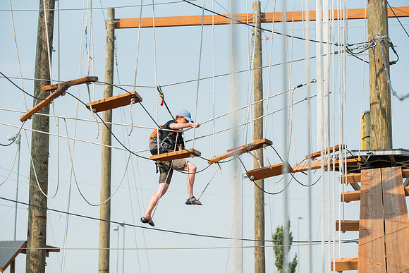 BYUI Students climbing around the ropes course by the upper fields in the summer of 2021.
