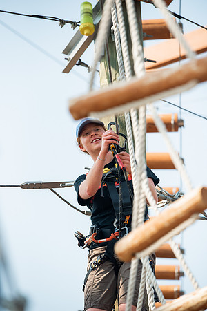 BYUI Students climbing around the ropes course by the upper fields in the summer of 2021.