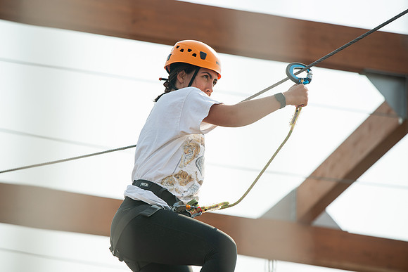 BYUI Students climbing around the ropes course by the upper fields in the summer of 2021.