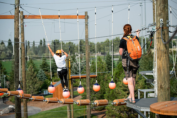 BYUI Students climbing around the ropes course by the upper fields in the summer of 2021.