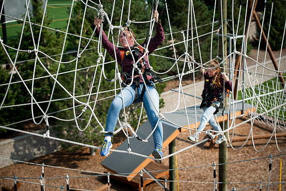 BYUI Students climbing around the ropes course by the upper fields in the summer of 2021.