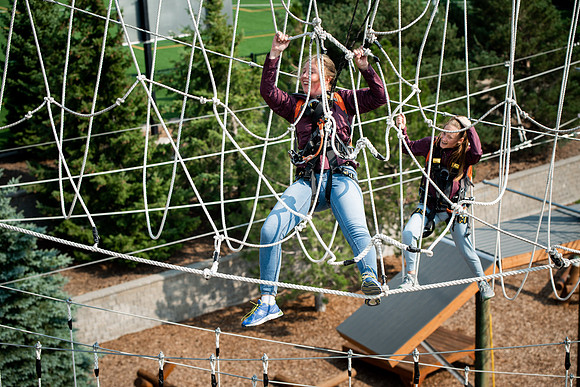 BYUI Students climbing around the ropes course by the upper fields in the summer of 2021.