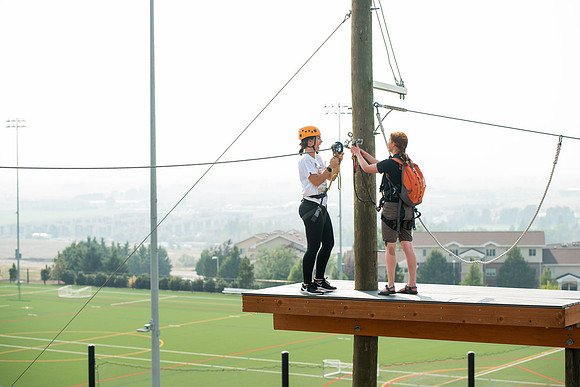 BYUI Students climbing around the ropes course by the upper fields in the summer of 2021.