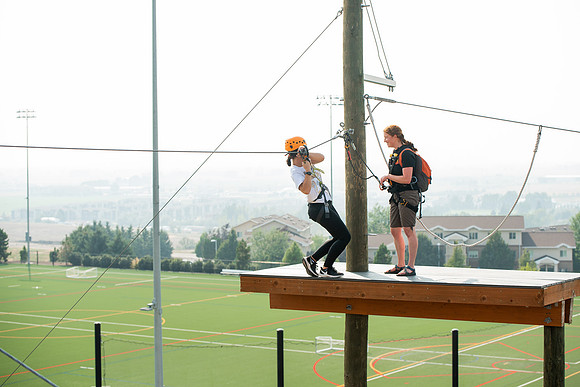 BYUI Students climbing around the ropes course by the upper fields in the summer of 2021.