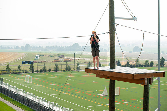 BYUI Students climbing around the ropes course by the upper fields in the summer of 2021.