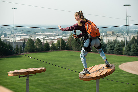 BYUI Students climbing around the ropes course by the upper fields in the summer of 2021.