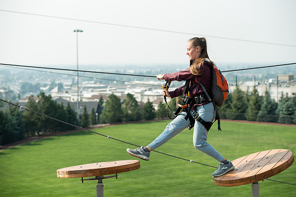 BYUI Students climbing around the ropes course by the upper fields in the summer of 2021.