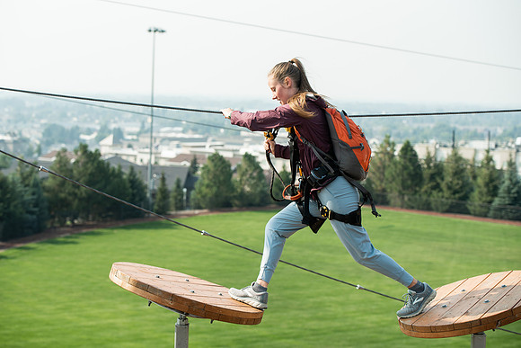 BYUI Students climbing around the ropes course by the upper fields in the summer of 2021.