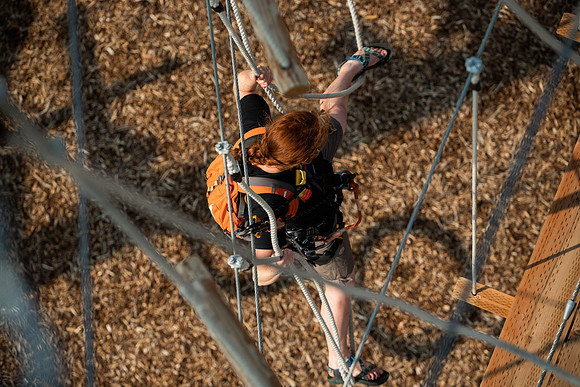 BYUI Students climbing around the ropes course by the upper fields in the summer of 2021.