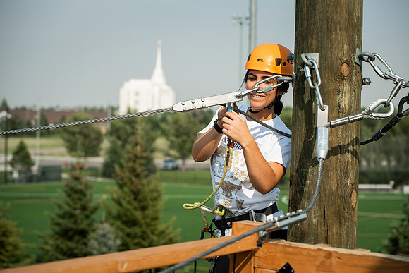 BYUI Students climbing around the ropes course by the upper fields in the summer of 2021.