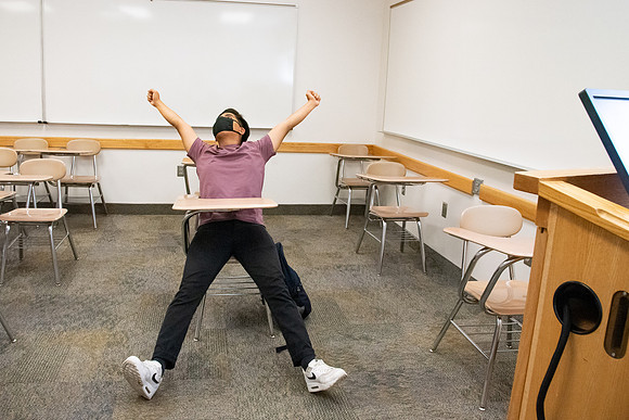 Examples of students staying safe and healthy during the COVID-19 pandemic by social distancing, following pathway arrows, and wearing face masks.