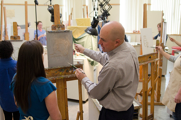 David Belka enthusiatically teaches painting principles to beginning painting class.