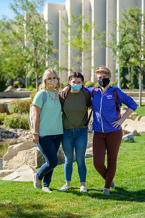 Student volunteers show the way to stay safe during this COVID 19 pandemic by social distancing, following pathway arrows and proper wearing of masks .