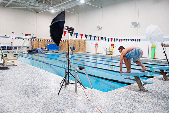 Behind the scenes of Mike Lewis shooting frisbee, football, and swimming photos for Hart gym decals.