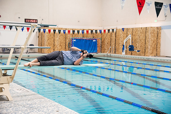 Behind the scenes of Mike Lewis shooting frisbee, football, and swimming photos for Hart gym decals.