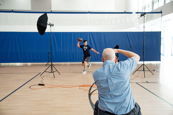 Behind the scenes of Mike Lewis shooting frisbee, football, and swimming photos for Hart gym decals.