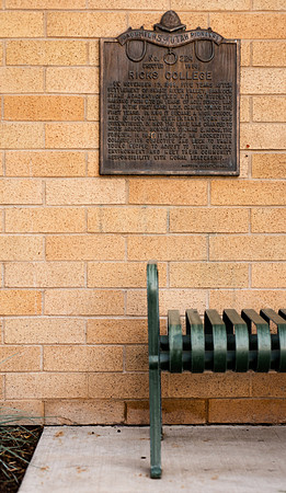 Ricks College plaque and green bench beside the Snow building in the summer of 2021.