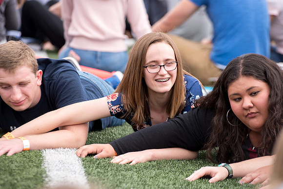Students make new friends and get acquainted with other new students in their I-Team at the Football Field