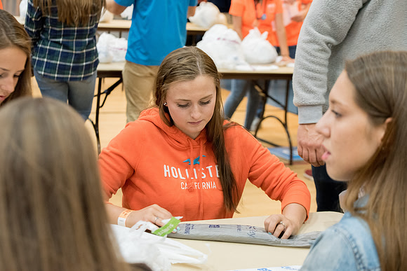 Students are assembling hygiene kits, braiding jump ropes and making plarn for plastic sleep mats.