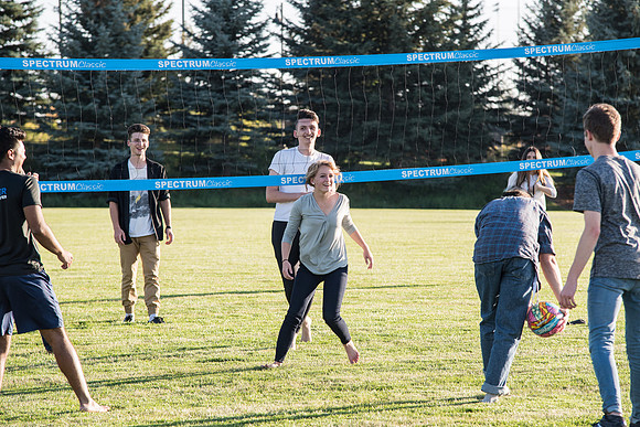 Members of the Student Representative Council play volleyball with fellow students.