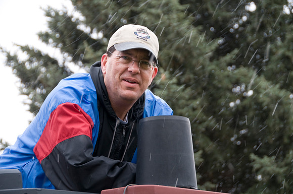 Lee Warnick inspects his raingage which helps him calculate the amount of moisture recieved each day.