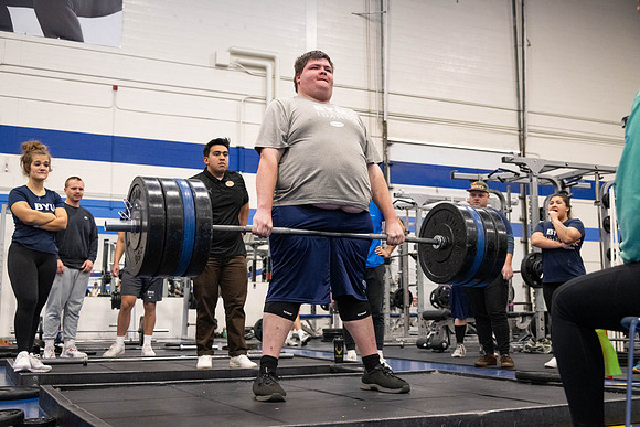 Students compete in Squat Bench and Deadlift challenges. In the BYU-Idaho gym in the Hart Building.
