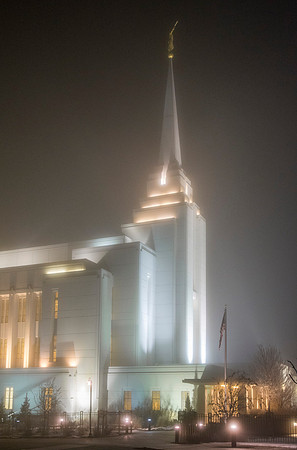 Rexburg Temple lights cut through the fog on a cold winter night.