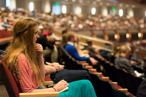 Student listens and takes notes at devotional.