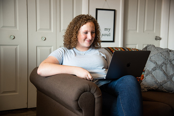 BYUI student Hannah Cobbley watches Sister Kelly and President Henry J. Eyring's devotional in her apartment at the start of the fall 2021 semester.