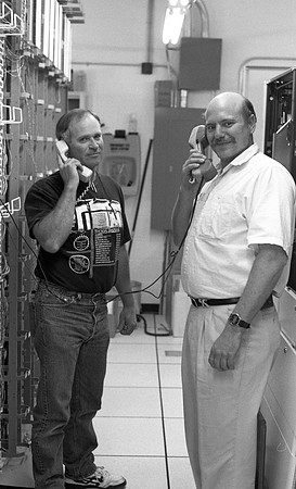 Employees check new switchboard telephone system.