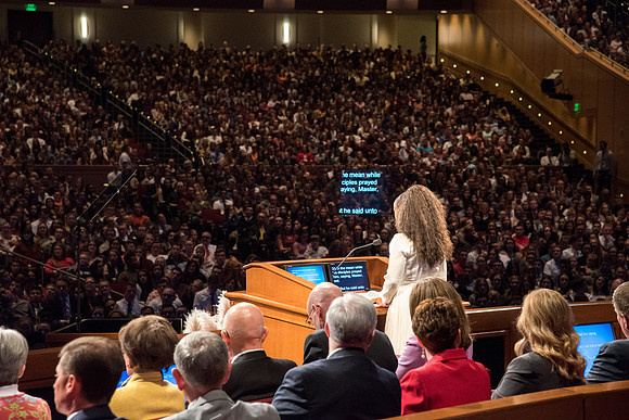 Student sharing the scripture at the devotional.