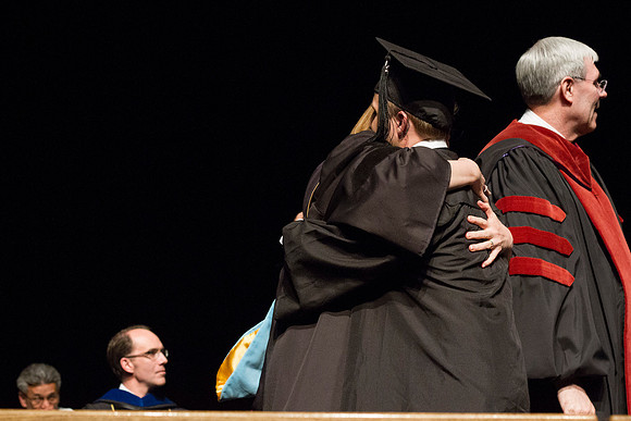 Robyn H. Bergstorm, Dean of the Business and Communication College congratulates a fellow student during Convocation in the Hart Auditorium.