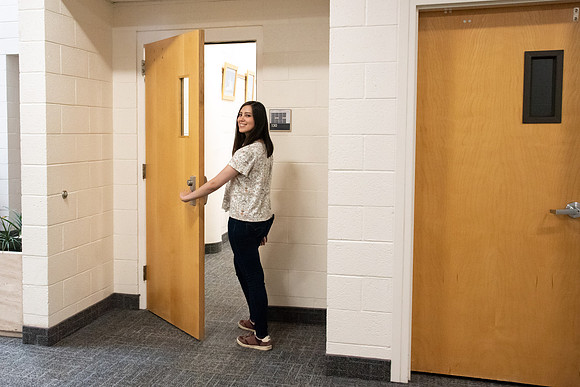 Examples of students staying safe and healthy during the COVID-19 pandemic by social distancing, following pathway arrows, and wearing face masks.