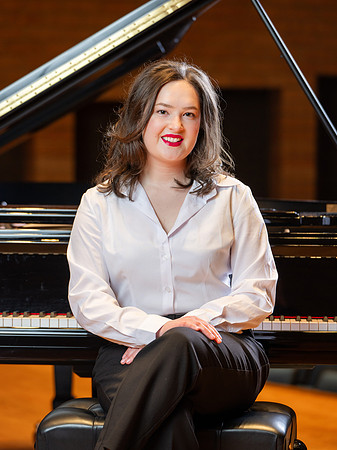 Music major, Kaitlynd Ruesch at the grand piano preparing for here senior recital in the Barrus Concert Hall.