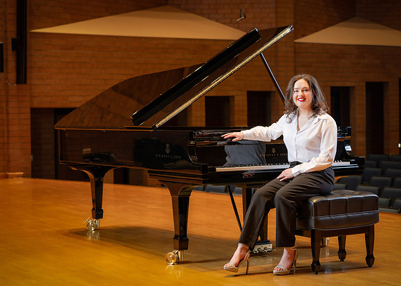 Music major, Kaitlynd Ruesch at the grand piano preparing for here senior recital in the Barrus Concert Hall.
