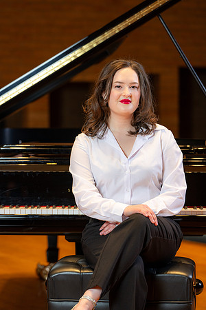 Music major, Kaitlynd Ruesch at the grand piano preparing for here senior recital in the Barrus Concert Hall.