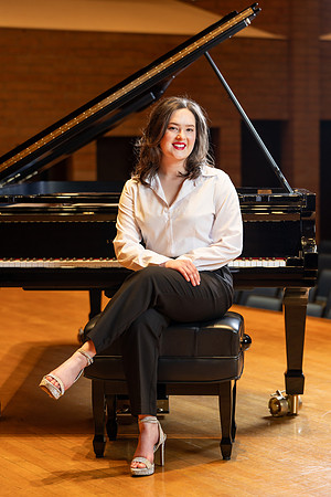 Music major, Kaitlynd Ruesch at the grand piano preparing for here senior recital in the Barrus Concert Hall.