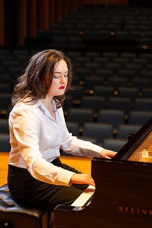 Music major, Kaitlynd Ruesch at the grand piano preparing for here senior recital in the Barrus Concert Hall.