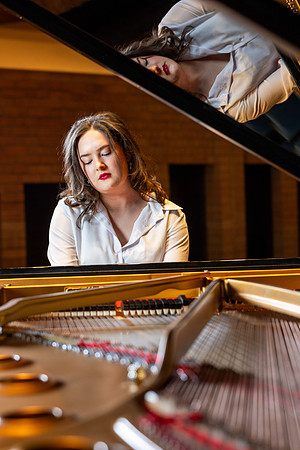 Music major, Kaitlynd Ruesch at the grand piano preparing for here senior recital in the Barrus Concert Hall.