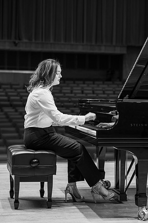 Music major, Kaitlynd Ruesch at the grand piano preparing for here senior recital in the Barrus Concert Hall.