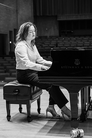Music major, Kaitlynd Ruesch at the grand piano preparing for here senior recital in the Barrus Concert Hall.