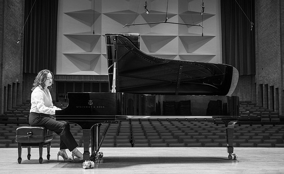 Music major, Kaitlynd Ruesch at the grand piano preparing for here senior recital in the Barrus Concert Hall.